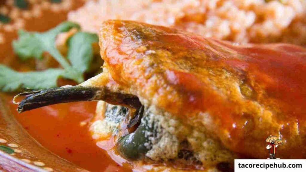 Chile rellenos served as a side dish for tacos, showcasing stuffed and fried peppers